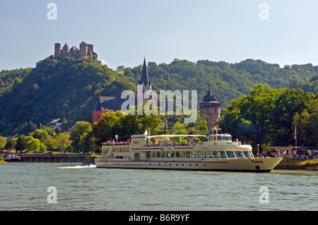 Oberwesel on Rhine River with river cruise ship, Schonburg Castle ruins on hill above town Stock Photo