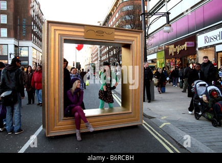 Models pose in Oxford Street, London during traffic-free Christmas shopping day Stock Photo