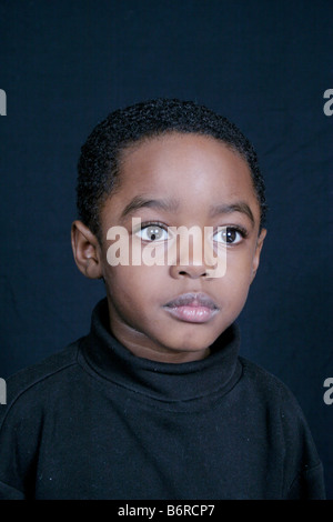 Thoughtful and cute African American boy Stock Photo - Alamy