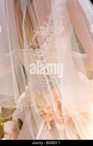 Back view of bride walking away from camera wearing intricate handmade Becky Drinan wedding dress . Picture by Jim Holden. Stock Photo