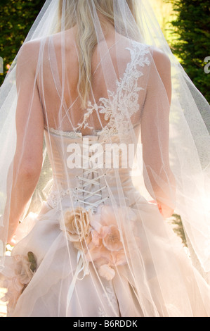 Back view of bride walking away from camera wearing intricate handmade Becky Drinan wedding dress . Picture by Jim Holden. Stock Photo