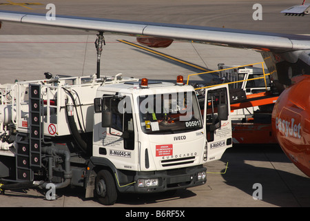 Fuel tanker refuelling a passenger jet aircraft at Palma airport. Stock Photo
