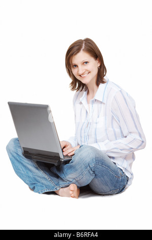 Happy woman sitting on floor in living room Stock Photo - Alamy