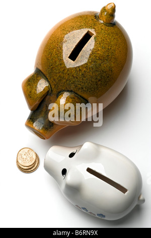 two piggy banks on white with coins Stock Photo