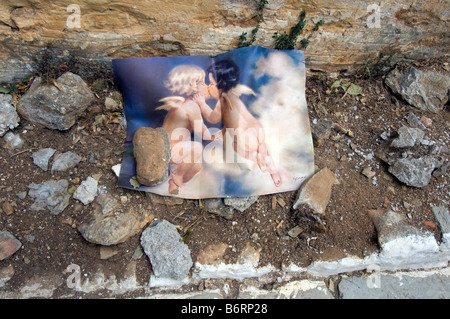 A discarded picture of two cherubs kissing Stock Photo
