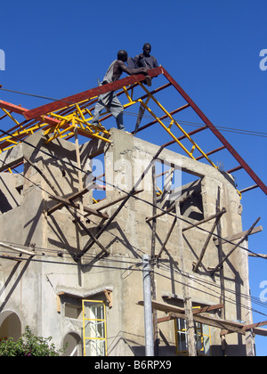 Unsafe work practice on a building site in The Gambia West Africa. Stock Photo