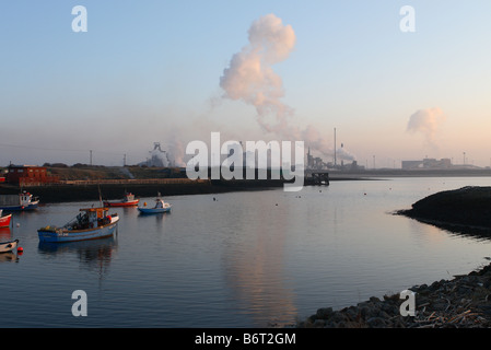 Evening sunset dusk over Paddys Hole harbour on South Gare of the River Tees at Teesmouth near Redcar Teesside with steelworks Stock Photo