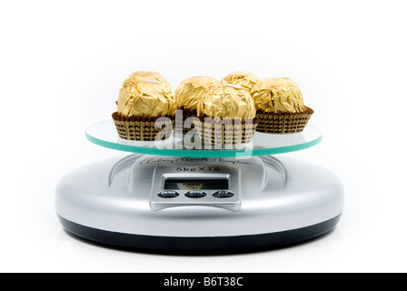 chocolate confectionary on a set of scales Stock Photo