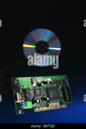 computer circuit board and CD suspended in mid air against a graduated blue background Stock Photo