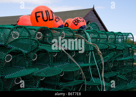 Lobster pots and floats piled up near the beach on the Holy Island of Lindisfarne, Northumberland. Stock Photo