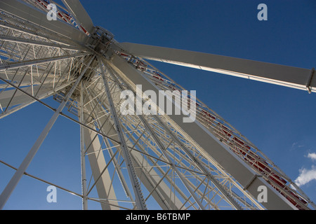 Looking up at ferris wheel against a blue sky Stock Photo