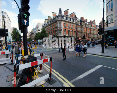 People crossing the street with broken traffic light on a busy Oxford Street London UK Stock Photo
