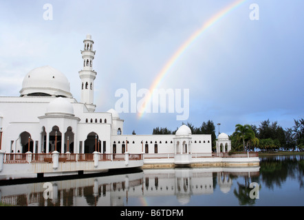 Rainbow and Tengku Tengah Zaharah Mosque in Terengganu, Malaysia, also popularly known as the Floating Mosque Stock Photo