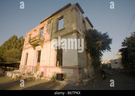 Abandoned building with outdoor cafe attached in the Green Line UN buffer zone, Nicosia, Cyprus Stock Photo
