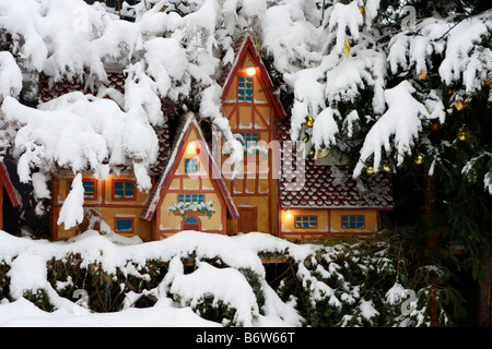 charming gingerbread type houses ,set in real snow ,are part of the outdoor nativity scene in Montemonaco,Le Marche,Italy Stock Photo