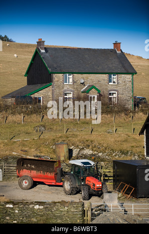 Remote welsh farmhouse tractor with muck spreader upper Elan Valley powys mid wales UK Stock Photo