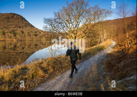 A man walking along the Elan Valley trail public footpath Powys mid wales January 2009 Stock Photo