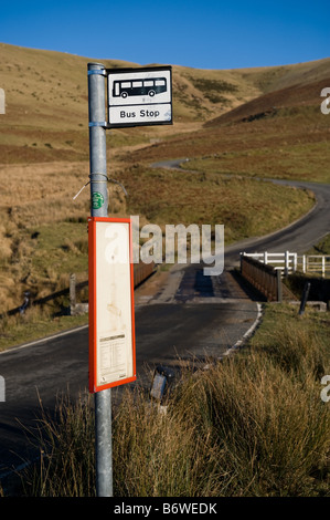 empty rroad and a remote rural bus stop sign in the Upper Elan valley powys mid wales UK Stock Photo