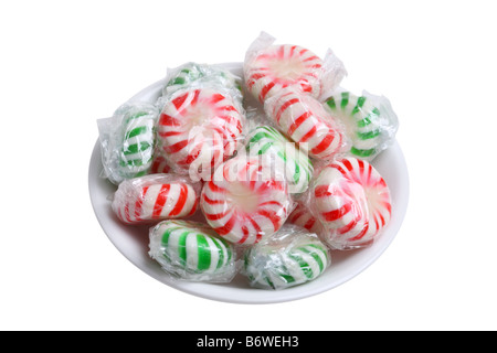 Small bowl of peppermint candies cut out isolated on white background Stock Photo
