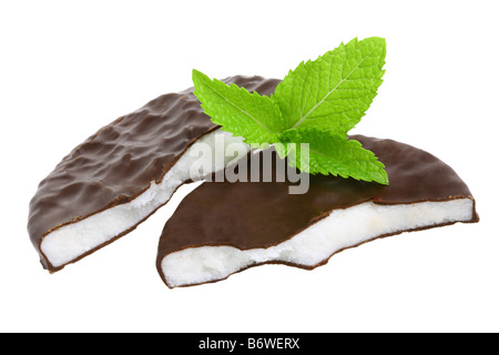 Peppermint patties and sprig of mint cut out isolated on white background Stock Photo