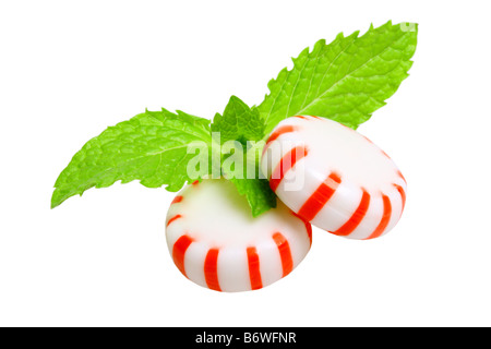 Peppermint candies and mint leaves cut out isolated on white background Stock Photo