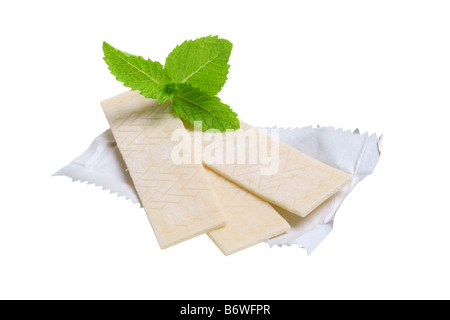 Chewing gum and mint leaves cut out isolated on white background Stock Photo