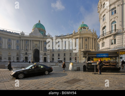 Taxi waiting for a fare beside a kiosk selling donuts, Michaelerplatz, Vienna, Austria Stock Photo