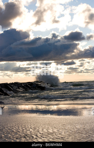 Wave crashing in rocks at New Buffalo Michigan Stock Photo