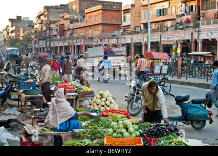 INDIA JAIPUR RAJASTHAN Busy street in the market area of Jaipur with colorful vegetables for sale and traffic of every kind Stock Photo