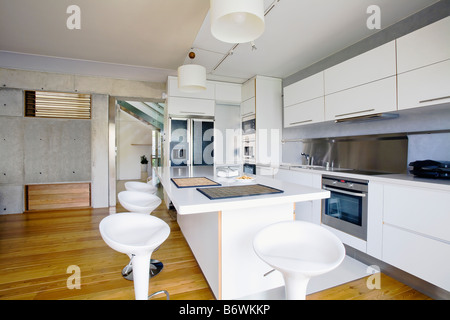 Modern white kitchen with breakfast bar and gothic style window