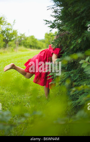 A girl looking in bushes