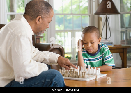 A grandfather and grandson playing chess Stock Photo