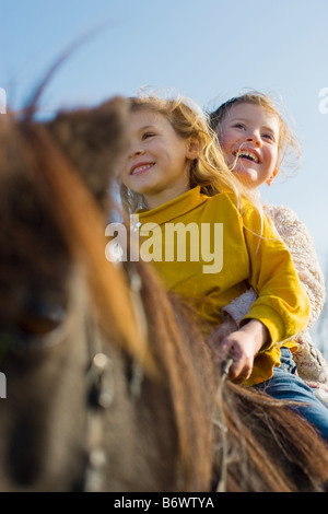 Girls riding a shetland pony Stock Photo