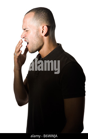 Young man yawning Stock Photo