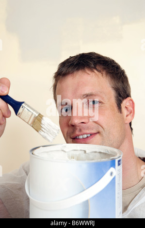 A man holding a paintbrush Stock Photo