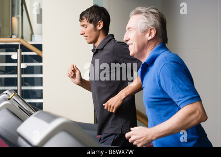 Two men running on a treadmill Stock Photo