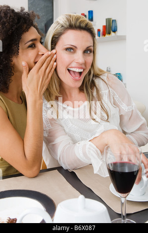 Two women whispering Stock Photo