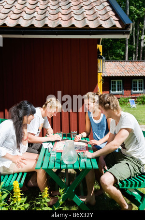 Four friends playing a board game Stock Photo