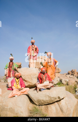 Five sadhus in a boulder, Hampi, Karnataka, India Stock Photo