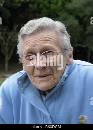 elderly woman feeling very cold due to freezing temperatures Stock Photo