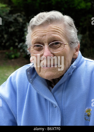 elderly woman feeling very cold due to freezing temperatures Stock Photo