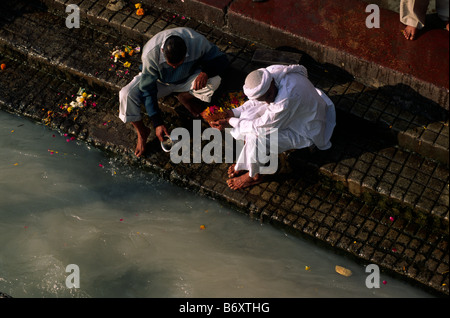 India, Uttarakhand, Haridwar, people giving offerings to the river Ganges Stock Photo