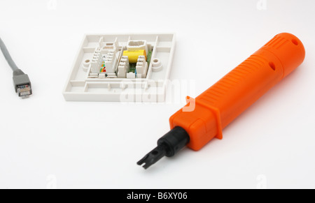 Punch-down tool next to RJ45 wall socket Stock Photo