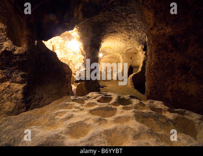 Food and water holes dug in the Kaymakkli underground city Cappadocia Turkey Stock Photo