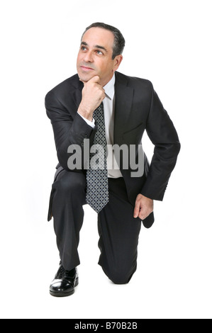 Thinking businessman in a suit isolated on white background Stock Photo