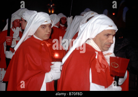 Penitents at Settimana Santa Holy Week Procession on Palm Sunday night in Enna Sicily Italy Stock Photo