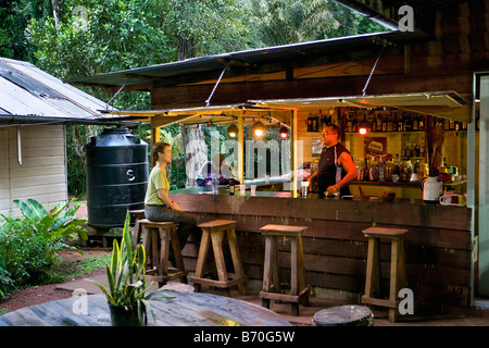 Suriname, Brownsweg, Brownsberg National Park. Tourist having a drink at bar of lodge. Stock Photo