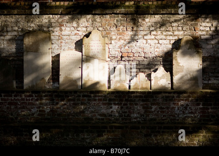 A collection of 19th century headstones along the east wall at Colonial Park Cemetery in Savannah, Georgia. Stock Photo