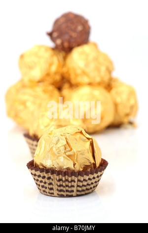 closeup gold wraped chocolate sphere dessert Stock Photo