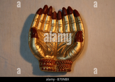 Manmade gold souvenir of two beautiful palms joined together as a sign of prayer or welcome and honor Diwali Festival of lights Stock Photo